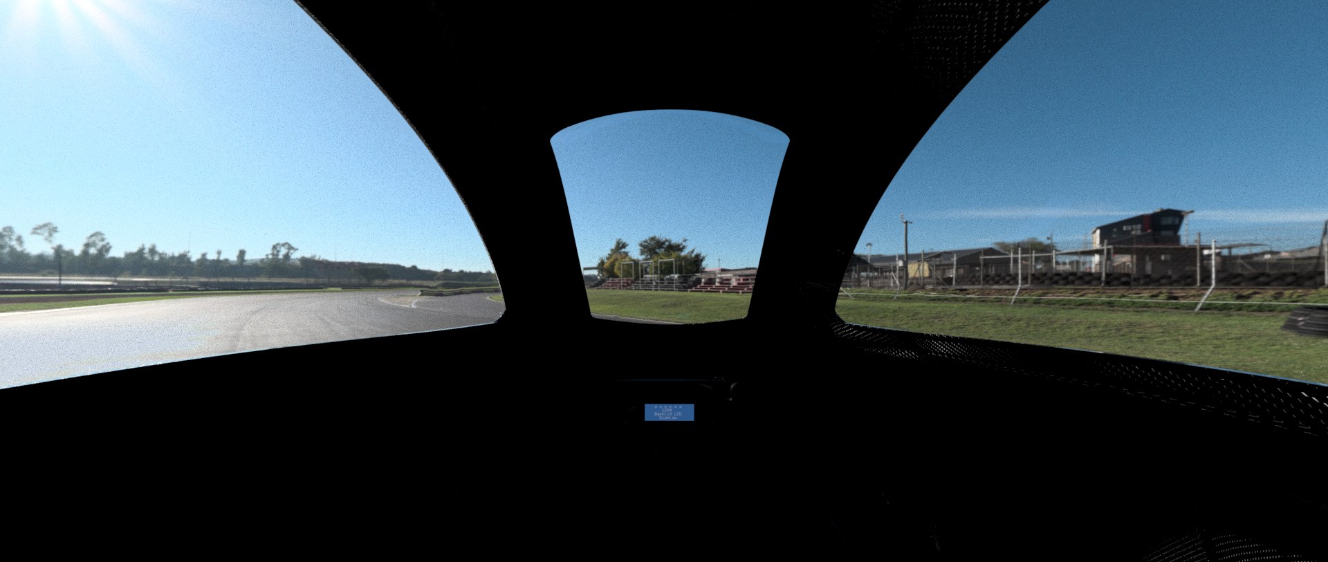 Driver's-eye view from inside the PYRFOROS IV cockpit, looking out over the nose at the track