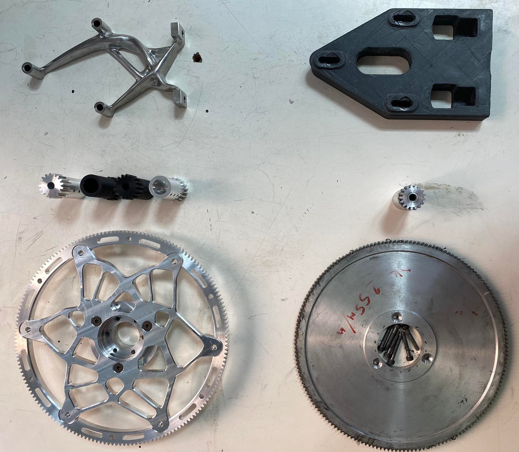 New vs. old motor mount, shaft, and driven gear